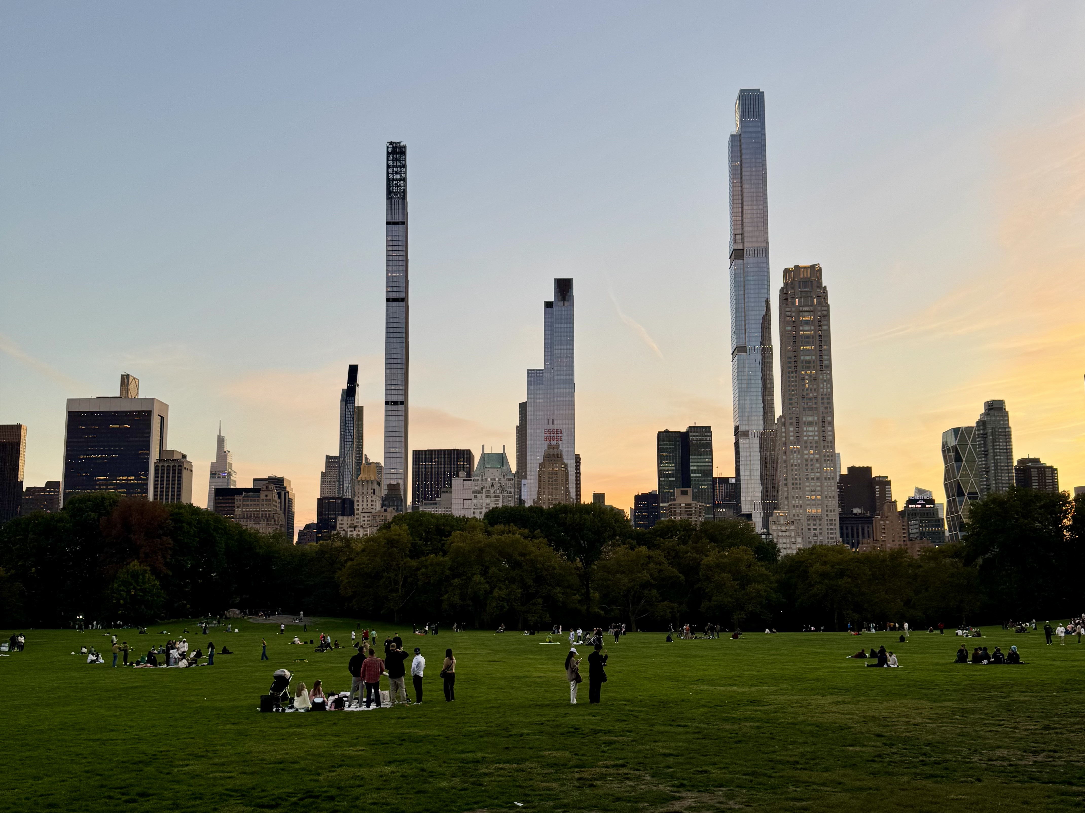Central Park lawn with the Manhattan skyline at sunset